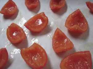 Toss quartered and seeded tomatoes with olive oil