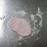 take a piece and press it down onto the table, use a little of the cornstarch to dust if it gets sticky