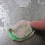 put a little food coloring on your finger and add it to the fondant