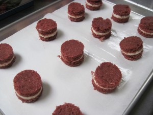 1 dozen cut out red velvet cakes waiting for marshmallow