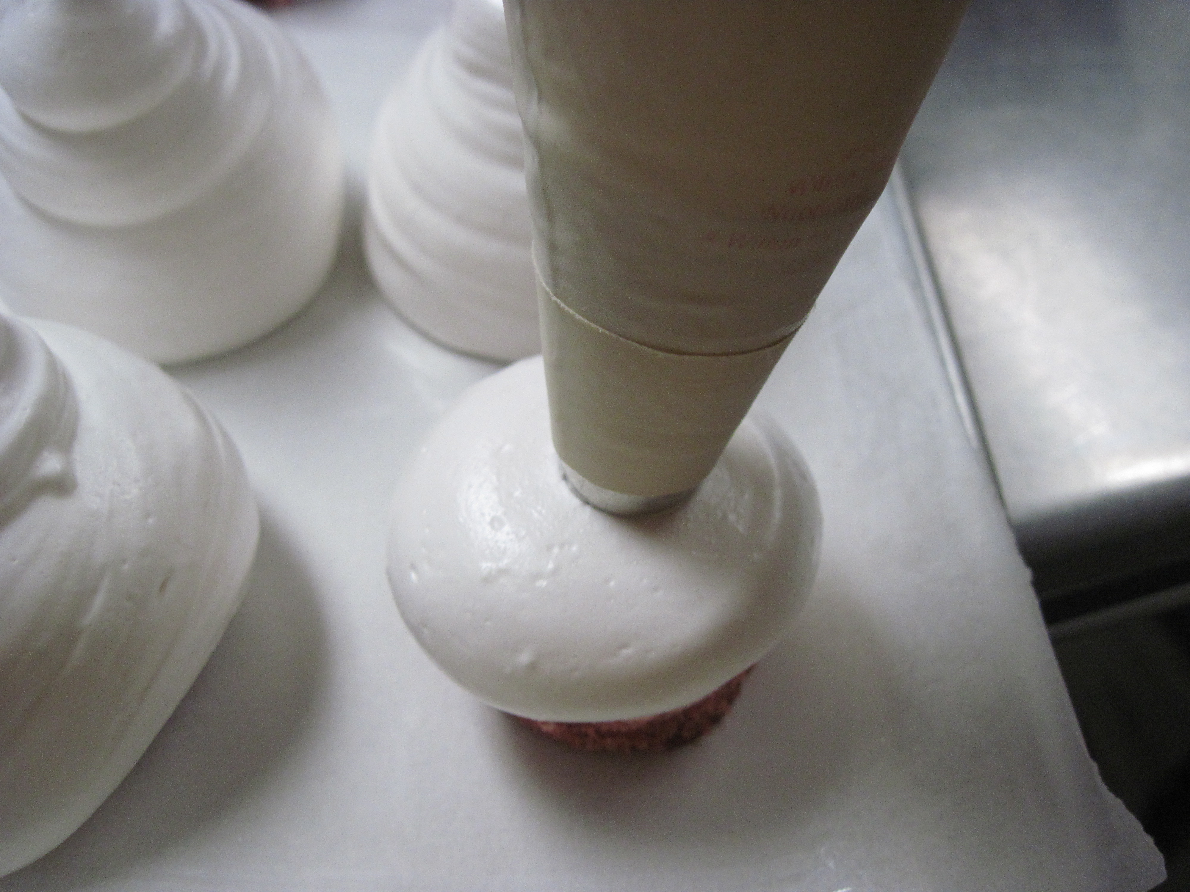 Start piping marshmallow until it falls over the sides of 