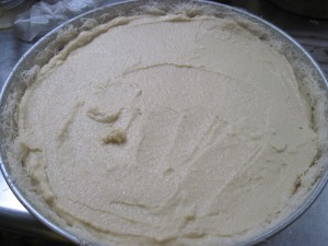 pour custard into kataifi line pan and even out