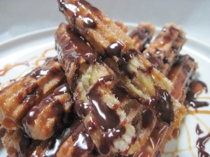 Perfectly crispy and creamy churros with cajeta sauce and chocolate drizzle