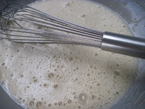 add half of the hot milk mixture to the eggs and set aside