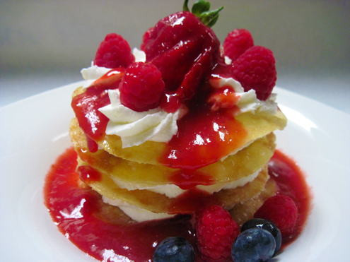 caramelized crepe napolean with whipped cream and assorted berries