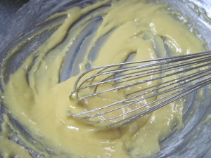 make a paste with yolks, half the sugar, oil and flour