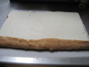 turn edge inward and then use the paper to roll the cake evenly the rest of the way