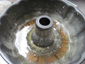 pour in caramel, swirl pan, allow to cool and then use pan spray on the rest of the pan