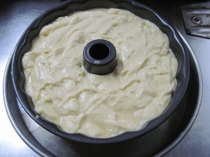 bundt pan filled with custard and cake batter, placed in another pan, add water, cover and bake