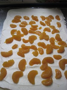 next add mandarin segments on top of custard
