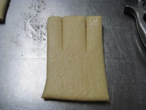 cut 3 strips at the top for the arms and the head