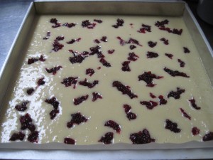 add the cranberry compote to the hot milk cake