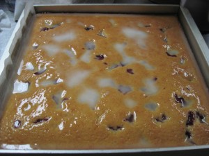 pour glaze all over the vodka cranberry lemon cake as it comes out of the oven