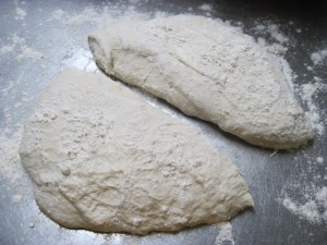 cut ciabatta dough into 2 equal halves and dust surface with flour