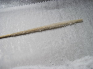 Wooden skewer dipped in corn syrup and then rolled in granulated sugar