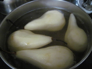 pears poaching in white wine syrup