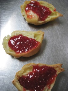 cut the eclair swan bodies in half and add a little jam or ganache