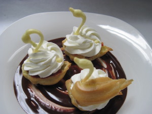 add the eclair dough necks to the swans and then add the wings