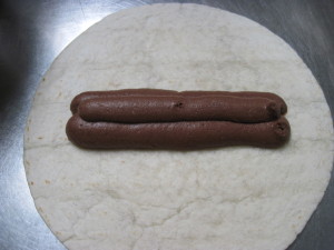 pipe chilled chocolate cream into the center of the filled tortilla