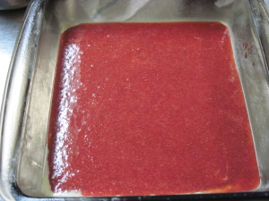 Pour half of the half cooked strawberry sauce into your sprayed baking dish