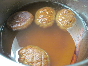 Hot Melomakaron right from the oven into the room temperature syrup